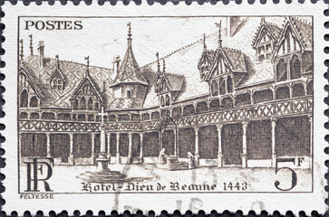 France - circa 1941: A postage stamp from France showing the historic Hôtel-Dieu de Beaune 1443