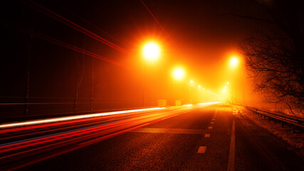 Night street with warm light. Long exposure.
