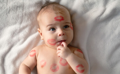 Cheerful baby with traces of kisses on the body. V