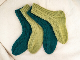 Green and teal colored handmade woolen socks