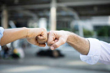 Success bumping their fists with colleagues.