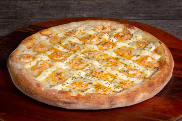 Tasty shrimp pizza with cream cheese on a wooden background, in Brazil it's called shrimp pizza...