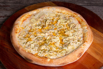 Tasty Mushroom Pizza on wooden background, in Brazil it's called pizza de cogumelos