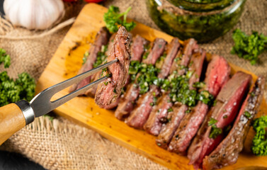 A piece of steak strung on a fork close-up.