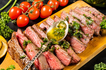 Juicy beef steak cut into pieces and sprinkled with chimichurri sauce.