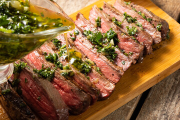Pour the beef steak on top with aromatic chimichurri sauce.