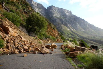 landslide of rocks blocking tarmac road  - obrazy, fototapety, plakaty