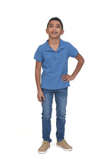Fototapeta premium full portrait of boy looking up and hands on hip on white background