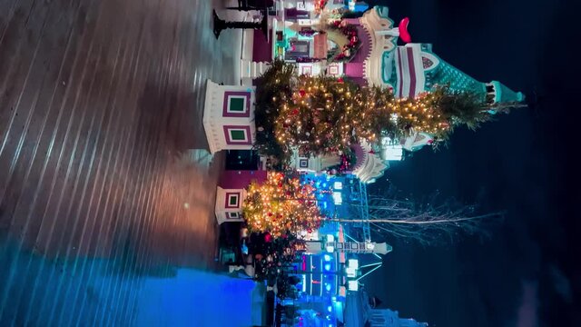Street decorated for New Year and Christmas. Night winter snow Moscow, Russia, December 19, 2021.Vertical video format High quality 4k footage
