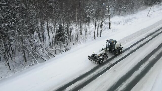 Snowblower cleans snow on the track. Aerial view