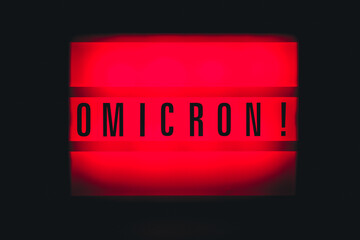 Sign with an inscription Omicron. Covid 19 Pandemic. Selective focus
