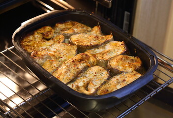 Fish baked in the oven on a baking sheet