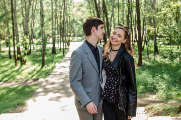 beautiful couple in love is hugging each other and standing next to each other. valentines day. guy and the girl are connected with each other in love. Happy couple smiling having fun while relaxing