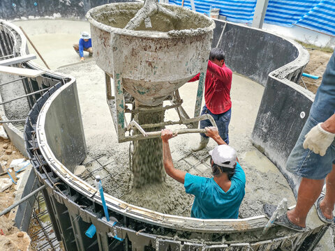  Swimming pool construction. Workers were pouring concrete work.construction work.