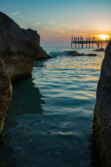 Sunset on Caspian Sea rocks and bridge