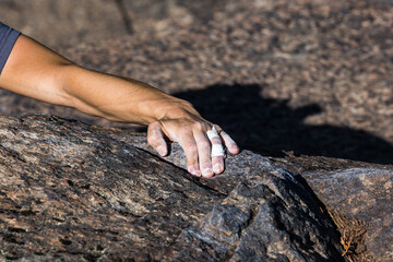 man climber holding a rock
