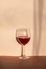 glass of red wine, natural sunlight and abstract shadow. retro styled photography 