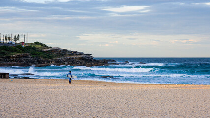 surfer on the beach at sunset