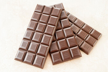 Handmade chocolate. Black bitter craft chocolate on white background. Healthy food concept, delicious chocolate sweets, diet, sugar