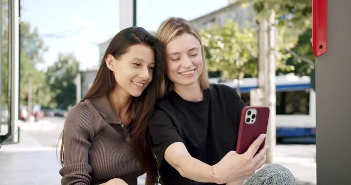 Cute girls take selfie photo outside. posing models, making a video call