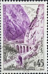 France - circa 1960: A post stamp from France showing a landscape with viaduct Kerrata Gorges,...