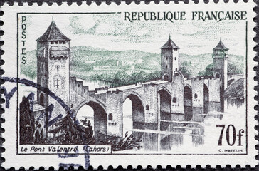 France - circa 1957: A post stamp from France showing the historic bridge from Valentre Bridge,...