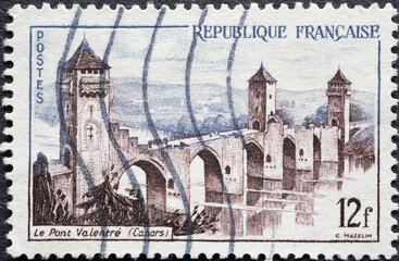 France - circa 1955: A post stamp from France showing a river with Valentré Bridge, Cahors
