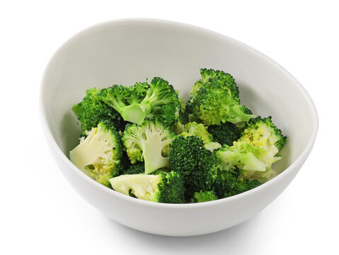 fresh steamed and sliced broccoli florets in white bowl isolated on white background