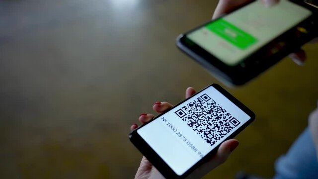 QR Code Scanner on the Smartphone close up. Checking the QR code of the vaccination certificate at the entrance to the building. QR Code Reader App.  - Powered by Adobe