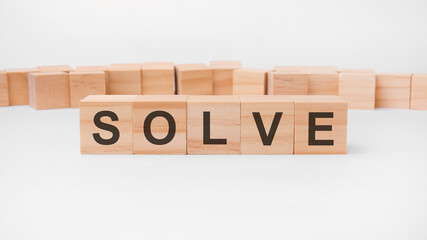 solve word, text, written on wooden cubes, building blocks, over white background