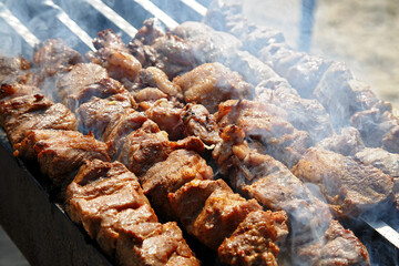 Delicious meat shashlik barbecue on skewers grilled on coals in the grill Russian cuisine