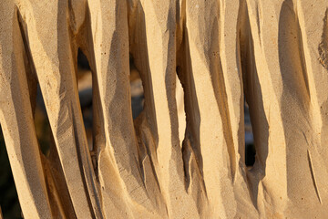 Abstract background of a stone sculpture. An ancient wall. Close-up. The texture of natural stone. Sunset light