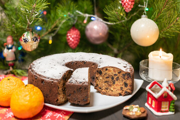 Fototapeta na wymiar Christmas cake on the background of a Christmas tree, background.