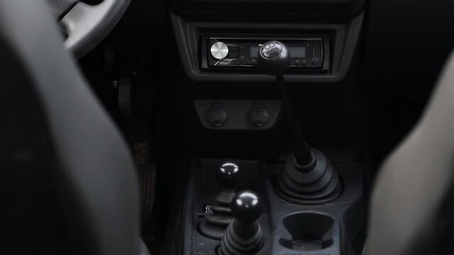 Separate shift lever for off-road vehicle functions. lowered range of gears. low gear and four-wheel drive. Front view.