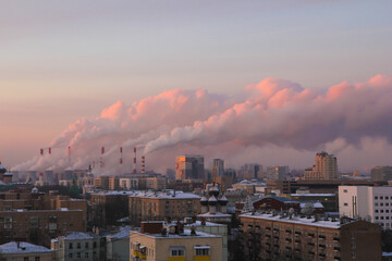 Morning cityscape with the picturesque smoke from the thermal power plant pipes.