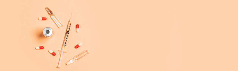 Syringe covid 19 corona virus liquid vaccine vial bottle injections. Colorful concept of New Corona virus 2019-nCoV or COVID-19 vaccine. Flat lay, top view, copy space.