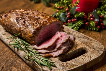 Sliced Baked roast meat, isolated on wooden background. High quality photo