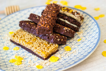 Granola energy bar with mix of nuts and fruits on a plate