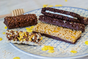 Granola energy bar with mix of nuts and fruits on a plate