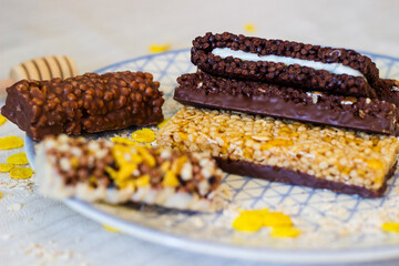Granola energy bar with mix of nuts and fruits on a plate