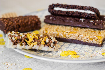 Granola energy bar with mix of nuts and fruits on a plate