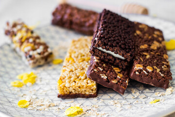 Granola energy bar with mix of nuts and fruits on a plate
