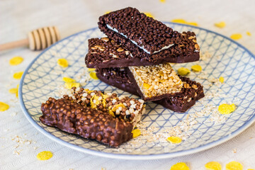 Granola energy bar with mix of nuts and fruits on a plate