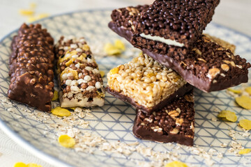 Granola energy bar with mix of nuts and fruits on a plate