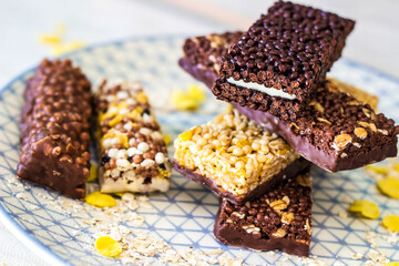 Granola energy bar with mix of nuts and fruits on a plate