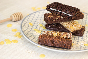 Granola energy bar with mix of nuts and fruits on a plate