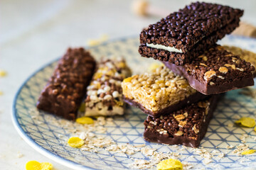 Granola energy bar with mix of nuts and fruits on a plate