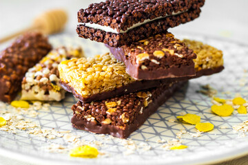 Granola energy bar with mix of nuts and fruits on a plate