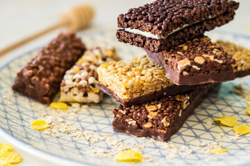 Granola energy bar with mix of nuts and fruits on a plate