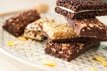 Granola energy bar with mix of nuts and fruits on a plate